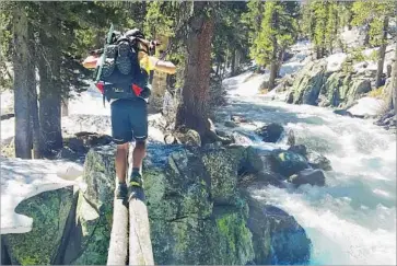  ?? Wesley Tils Via Associated Press ?? JAKE GUSTAFSON crosses Bear Creek along the Pacific Crest Trail near Kings Canyon National Park. After more than a dozen drownings at lower elevations this season, rangers are warning Sierra hikers.