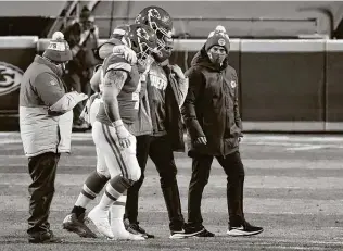  ?? Jamie Squire / Getty Images ?? Chiefs left Eric Fisher leaves the field in the fourth quarter Sunday after suffering what was diagnosed as a torn Achilles tendon that will force him to miss the Super Bowl.