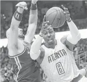  ?? Curtis Compton / Tribune News Service ?? Atlanta’s Dwight Howard beats Washington’s Marcin Gortat for one of his 15 rebounds Monday night. Howard’s double-double included 16 points.