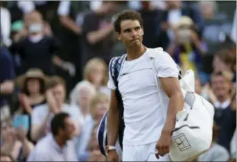  ?? THE ASSOCIATED PRESS ?? Spain’s Rafael Nadal leaves Monday at Wimbledon. the court after losing to Luxembourg’s Gilles Muller on