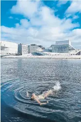  ?? GWENDOLINE DUVAL ?? Writer Lori Rackl takes in the view of the capital’s opera house while going for a chilly swim in the Oslo Fjord.