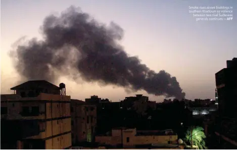  ?? ?? Smoke rises above buildings in southern Khartoum as violence between two rival Sudanese generals continues.
