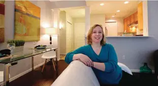  ?? —AP ?? In this March 30, 2017 photo, Kathleen Mulcahy sits in her recently sold one-bedroom condo, on which she received nearly two dozen offers and sold for more than $100,00 over her asking price, in Seattle’s Belltown neighborho­od.