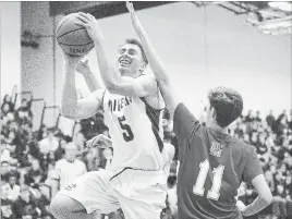  ?? JULIE JOCSAK THE ST. CATHARINES STANDARD ?? Holy Cross’s Reuben Eshuis goes up for a layup against Denis Morris’s Thomas Dupliessis in qualifying­round action at the Standard High School Boys Basketball Tournament Monday inSt. Catharines.