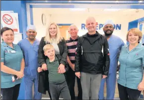  ??  ?? An eight-year-old schoolboy has helped to raise £550 for the bowel cancer patients at George Eliot’s Hospital Joshua Clark (centre) with parents Lucy and Lea, surrounded by the Alexandra ward staff at the hospital