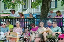  ??  ?? A crowd watches from the shade along the fence during the annual Noank-Mystic Community Band’s Fourth of July concert on Wednesday at Noank Park.