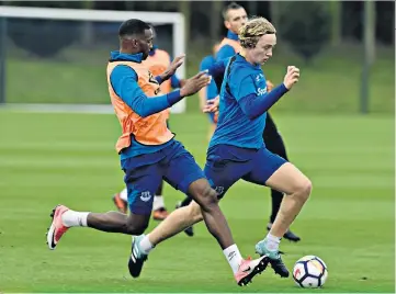  ??  ?? Full steam ahead: Tom Davies (right) leaves would-be tacklers in his wake during training for today’s game against Brighton