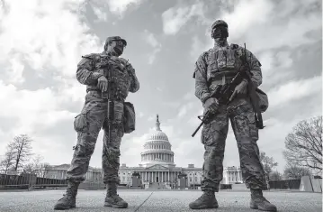  ?? SALWAN GEORGES The Washington Post ?? Members of the National Guard stand on the Capitol grounds on Jan. 15 in Washington. A current threat appears to be connected to a far-right conspiracy theory that former President Donald Trump will rise again to power today.