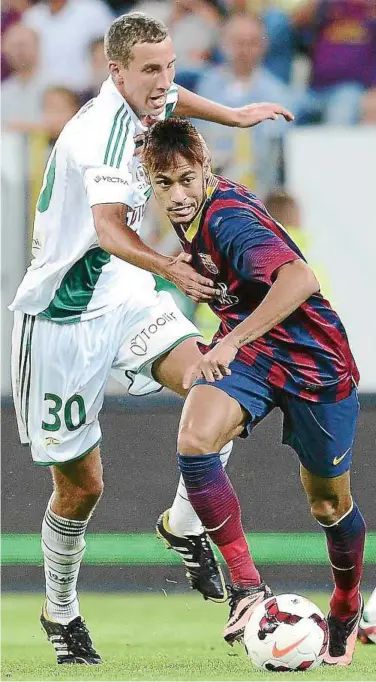  ??  ?? Move away: Barcelona forward Neymar (right) tries to dribble past Polish side Lechia Gdansk’s Maciej Kostrzewa during a friendly at the PGE Arena in Gdansk on Tuesday. The match ended 2-2. — AFP