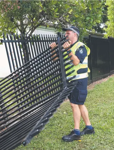  ?? Picture: ANNA ROGERS ?? FATAL CRASH: Forensic Crash Sergeant Scott Izard at the scene where a driver died after her car hit a fence in Gatton St after it was in an earlier minor crash.