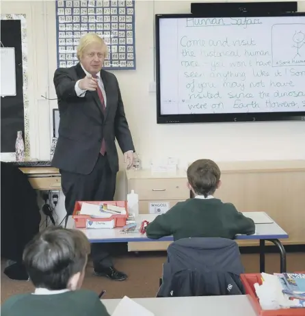  ?? PICTURE: AFP VIA GETTY IMAGES ?? 0 Boris Johnson joins a socially distanced lesson at a primary school in Hemel Hempstead