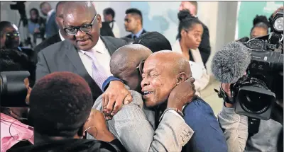  ?? Picture: ALAISTER RUSSELL ?? EMOTIONAL MOMENT: Family members of Esidimeni victims, the Rev Joseph Maboe, left, and Andrew Pietersen, embrace in relief and celebratio­n yesterday after former deputy chief justice Dikgang Moseneke ordered that the government pay R1.2-million to the...