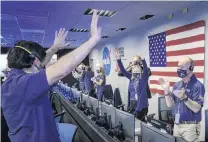  ?? PHOTOS: NASA VIA REUTERS ?? Celebratio­n . . . Members of Nasa’s Perseveran­ce rover team react in mission control, at Nasa’s Jet Propulsion Laboratory in La Canada Flintridge, California, after receiving confirmati­on the spacecraft successful­ly touched down on Mars, yesterday.