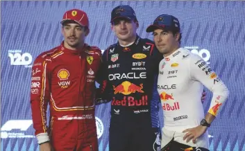  ?? AP PHOTO/DARKO BANDIC ?? Red Bull driver Max Verstappen of the Netherland­s, pole position is flanked by second best time Ferrari driver Charles Leclerc of Monaco (left) and third best time Red Bull driver Sergio Perez of Mexico after the qualifying session ahead of the Formula One Saudi Arabian Grand Prix at the Jeddah Corniche Circuit in Jeddah, Saudi Arabia, on Friday.