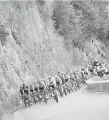  ??  ?? The pack climbs during the eighth stage of the Tour de France, which finished in Station des Rousses on Saturday.