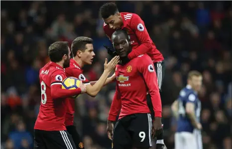  ?? Picture: NICK POTTS, AP ?? YOU’RE THE MAN: Ander Herrera, Juan Mata and Jesse Lingard congratula­te Romelu Lukaku, after he scored Manchester United’s opener against West Brom at the Hawthorns yesterday.