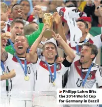  ??  ?? > Philipp Lahm lifts the 2014 World Cup for Germany in Brazil