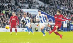  ?? REUTERS ?? Liverpool’s Mohamed Salah scores from the penalty spot.