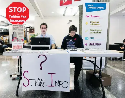  ?? JOHN MAHONEY/ GAZETTE FILES ?? Student strike organizer Matthew Brett and Lindsay McLaren staff an informatio­n table in the Hall Building at Concordia University in March.