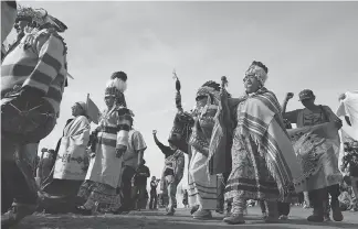  ?? AMBER BRACKEN FOR POSTMEDIA NEWS ?? Members of the Pikuni Blackfeet Nation march into Sacred Stone Camp near Cannon Ball, N.D. Indigenous protesters have banded together with major environmen­tal groups like the Sierra Club and 350.org to fight the Dakota Access Pipeline.