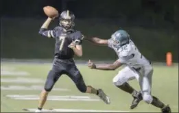  ?? JOHN BLAINE/ FOR THE TRENTONIAN ?? Hopewell Valley quarterbac­k Brennan Rouse, left, attempts to throw the ball while being pressured by Steinert’s Josh James, right, during Friday night’s game.