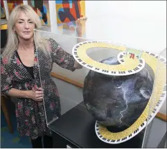  ??  ?? Artist Jackie Edwards with the globe she created.