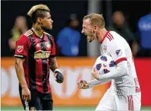  ?? CURTIS COMPTON/CCOMPTON@AJC.COM ?? As Josef Martinez looks on, the New York Red Bulls’ Daniel Royer celebrates scoring a penalty against Atlanta United to tie the game 1-1. The Red Bulls won 3-1.