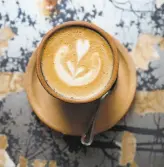  ??  ?? Jennifer Mays (left) and Joe Chernay, both of San Francisco, have coffee with Milton Davis of New Jersey at Four Barrel Coffee. The roaster promised to shift ownership to employees after a sexual harassment lawsuit.