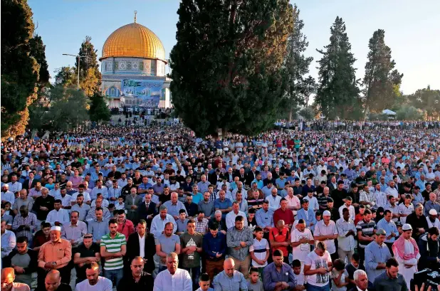  ?? AFP ?? IN CONGREGATI­ON: Palestinia­ns offer Eid Al Fitr prayer near Al Aqsa Mosque compound in the Old City of occupied Jerusalem on Sunday. —