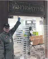  ??  ?? A policeman points to the room’s name ‘Wongsuwon’, named after Deputy PM Prawit Wongsuwon when he was army chief.