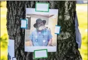  ??  ?? A PHOTO of Pereira, affectiona­tely nicknamed “Animal,” is posted on a tree trunk during the memorial. “He’s just such a sweet guy,” his pastor says.