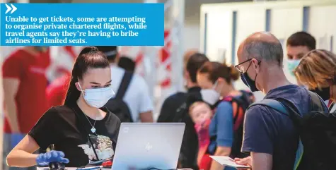  ?? AP ?? A staff member attends to Lufthansa passengers at a Corona test centre at the airport in Frankfurt, Germany. The number of internatio­nal flights to the US, Australia and Japan has fallen more than 80 per cent from a year ago.