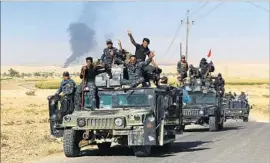  ?? Ahmad al-Rubaye AFP/Getty Images ?? IRAQI SOLDIERS celebrate last week after seizing control of two large oil fields west of Kirkuk, a blow to Kurds’ hopes of establishi­ng an independen­t state.