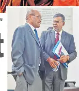  ?? Picture: JOVESA NAISUA ?? Minister for Infrastruc­ture Jone Usamate (left) in discussion with Opposition MP Professor Biman Prasad during a break in Parliament.
