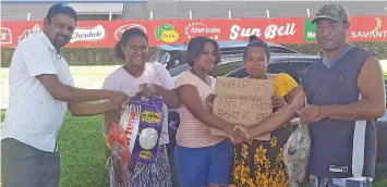  ?? Photo: Salote Qalubau ?? Lautoka Residents and Ratepayers Associatio­n member Narayan Reddy (left) and Ana Masere (second from right) barter fish for clothes from Raijieli Lakena (second from left) and Ecelina Tamani (third from left) in Navutu, Lautoka, on May 28, 2020. On the far right is Wili Drasuna.