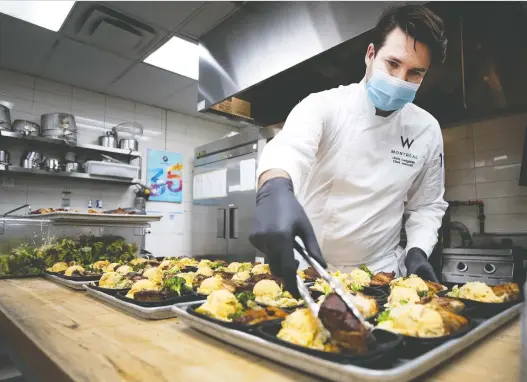  ?? ALLEN MCINNIS ?? Executive chef Joris Larigaldie plates all 600 meals made by the W Hotel for the homeless to reduce the number of people that touch the outgoing meals prior to shipment.