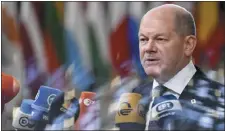  ?? GEERT VANDEN WIJNGAERT — THE ASSOCIATED PRESS ?? Germany’s Chancellor Olaf Scholz speaks with the media as he arrives for an EU summit in Brussels on Thursday.