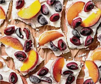  ?? Scott Suchman / for the Washington Post ?? Top frozen yogurt bark with cut up pieces of peaches and cherries for a sweet treat.