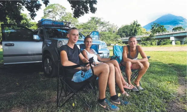  ?? Picture: STEWART McLEAN ?? PARADISE FOUND: German backpacker­s Ruben Japp, Magdalena Baltz and Cain Van Cauwenberg­h relax at Greenpatch Reserve, Gordonvale.
