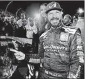  ?? MATT SULLIVAN/GETTY ?? Martin Truex Jr. celebrates after winning Sunday’s playoff race at Martinsvil­le.