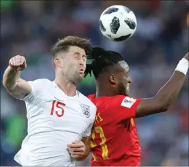  ?? The Associated Press ?? England’s Gary Cahill, left, and Belgium’s Michy Batshuayi challenge for the ball during the group G match between England and Belgium at the 2018 soccer World Cup in Kaliningra­d, Russia, Thursday.