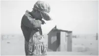  ?? ARTHUR ROTHSTEIN/FARM SECURITY ADMINISTRA­TION/LIBRARY OF CONGRESS ?? A farmer’s son wipes off dust from his face in Cimarron County, Okla., in April 1936.