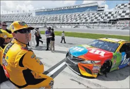  ?? John Raoux ?? The Associated Press Kyle Busch, left, watches the leaderboar­d during Daytona 500 qualifying. He says winning the race is a priority as he enters the 2018 NASCAR season.