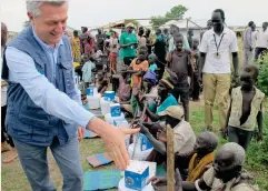  ??  ?? UNHCR High Commission­er for Refugees Filippo Grandi meets displaced civilians moving to a new camp in Bentiu, South Sudan, on Sunday. (Reuters)