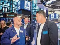  ?? Courtney Crow / New York Stock Exchange via AP ?? Trader Fred Demarco, left, talks with retired Italian soccer player Christian Vieri, right, who was part of a Serie A delegation to visit the New York Stock Exchange on Tuesday.