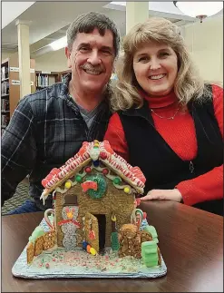  ?? (AP/The Monroe News/Tom Hawley) ?? Tom and Linda Hawley of Monroe took part in decorating one of Sandy Bergquist’s gingerbrea­d houses at the Dorsch Branch Library in Monroe, Mich.