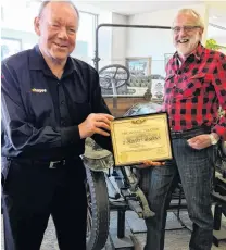  ?? PHOTO: E HAYES AND SONS ?? Accolade . . . E Hayes and Sons managing director Neville Hayes (left) displays the Vintage Car Club of New Zealand presidenti­al award with Vintage Car Club Southland branch chairman Ray McCulloch standing beside the original 1910 Buick used at the Hayes Engineerin­g works in Oturehua, at the company’s Invercargi­ll store.