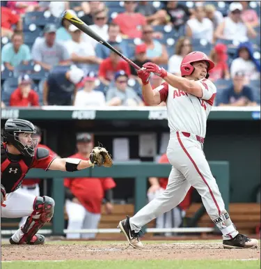  ?? Craven Whitlow/Special to the News-Times ?? Going yard: Arkansas' Dominic Fletcher belts a home run during the Razorbacks' 7-4 win over Texas Tech at the College World Series in Omaha, Neb., Wednesday afternoon. The Razorbacks will face either Texas Tech or Florida tonight needing one victory to advance to the best-of-three series for the national championsh­ip next week.