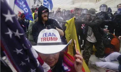  ?? ?? Rioters try to break through a police barrier at the Capitol in Washington on 6 January. Photograph: John Minchillo/AP