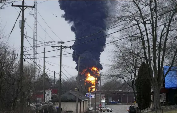  ?? Gene J. Puskar/Associated Press ?? A black plume rises over East Palestine, Ohio, on Monday after the controlled release of toxic gas from train cars following a derailment Friday.